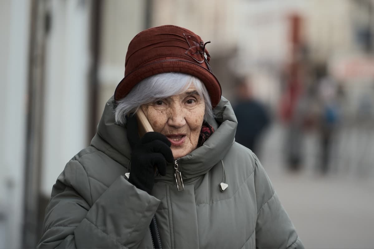 Elderly woman talking on a mobile phone outdoors