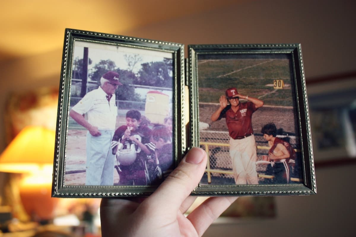 Hands holding two vintage black-and-white family photographs